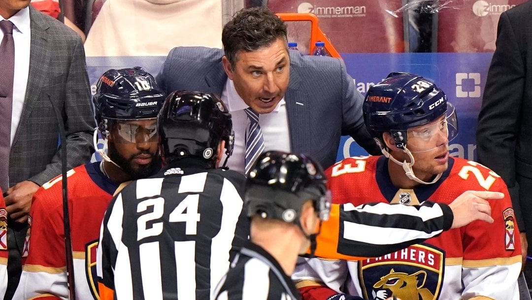 Florida Panthers interim head coach Andrew Brunette, center, talks with left wing Anthony Duclair, left, center Carter Verhaeghe (23) and referee Graham Skilliter (24) during the third period of an NHL hockey game, Thursday, Dec. 30, 2021, in Sunrise, Fla. The Panthers won 9-3.