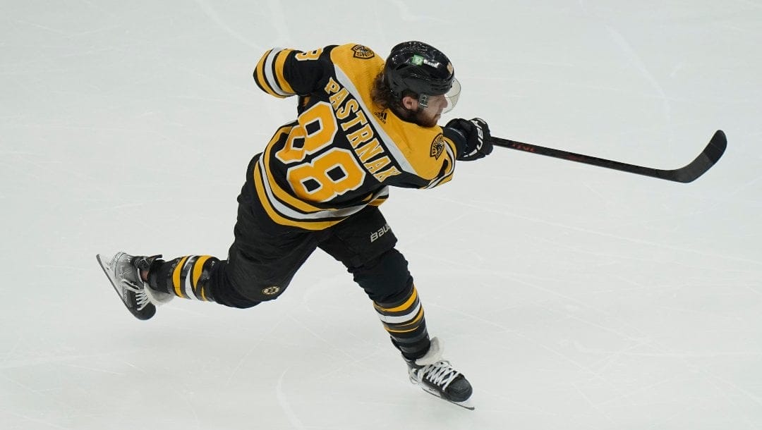 Boston Bruins right wing David Pastrnak takes a shot at the goal in the first period of an NHL hockey game against the Toronto Maple Leafs, Thursday, April 6, 2023, in Boston.