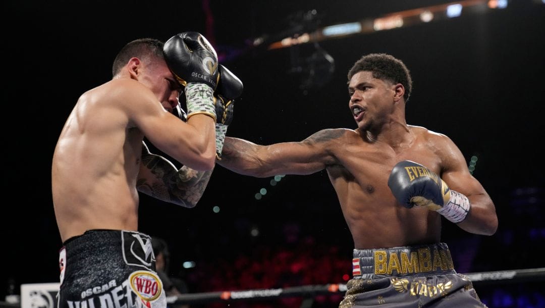 Shakur Stevenson, right, throws a punch at Oscar Valdez during a WBC-WBO junior lightweight title boxing bout Saturday, April 30, 2022.