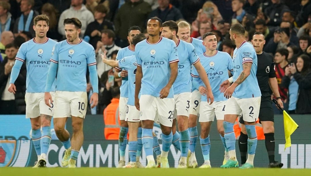 Manchester City players celebrate after Manchester City's Phil Foden, second right, scored his side's third goal during the English Premier League soccer match between Manchester City and West Ham United at Etihad stadium in Manchester, England, Wednesday, May 3, 2023. (AP Photo/Dave Thompson)
