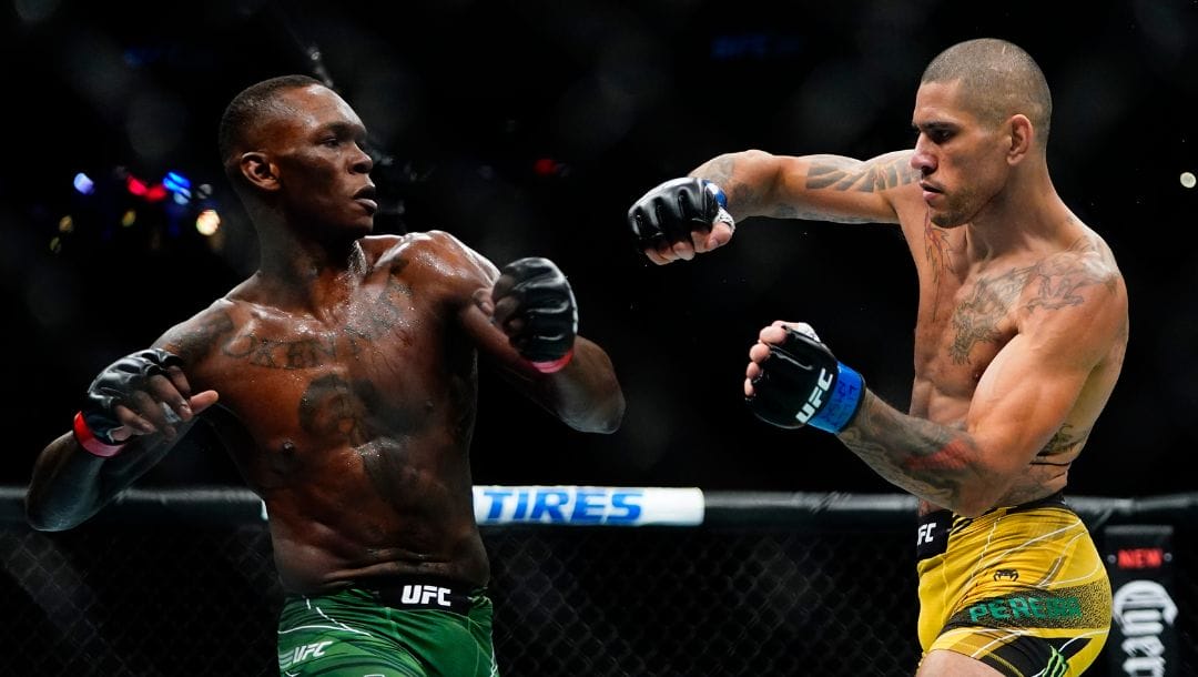 Brazil's Alex Pereira, right, fights Nigeria's Israel Adesanya during the first round of a middleweight bout title bout in the UFC 281.