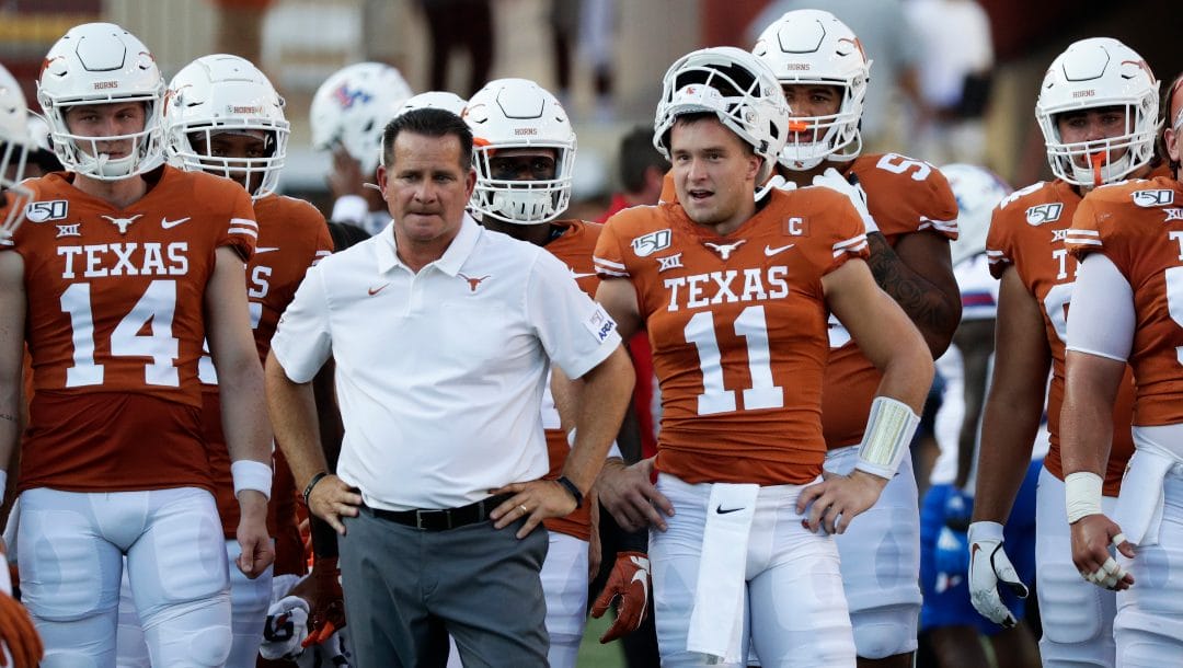 Texas quarterback Sam Ehlinger (11) stands with offensive coordinator and quarterbacks coach Tim Beck during the first half of an NCAA college football game, Saturday, Aug. 31, 2019, in Austin, Texas.