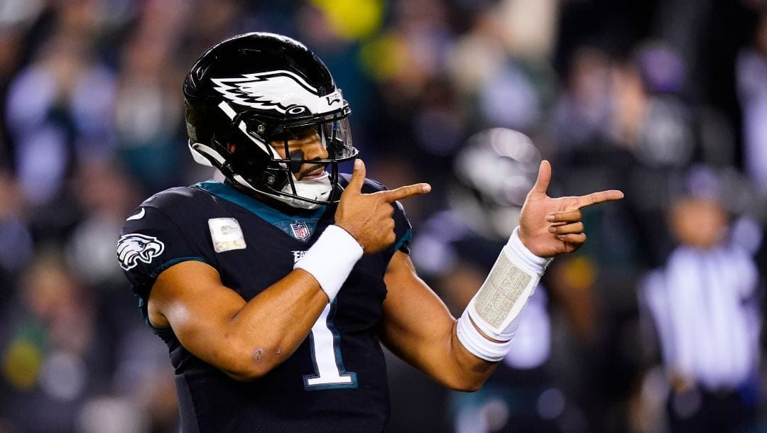 Philadelphia Eagles quarterback Jalen Hurts celebrates a touchdown run by Kenneth Gainwell during the first half of the team's NFL football game against the Green Bay Packers on Nov. 27, 2022, in Philadelphia. Jalen Hurts is set to sign one of the richest deals in NFL history, agreeing to a five-year, $255 million extension with the Philadelphia Eagles, including $179.3 million guaranteed, a person with knowledge of the situation told The Associated Press. The Eagles announced on Monday, April 17, “QB1 is here to stay,” but terms were not yet announced, according to the person who spoke to the AP on condition of anonymity because the deal was not yet final.