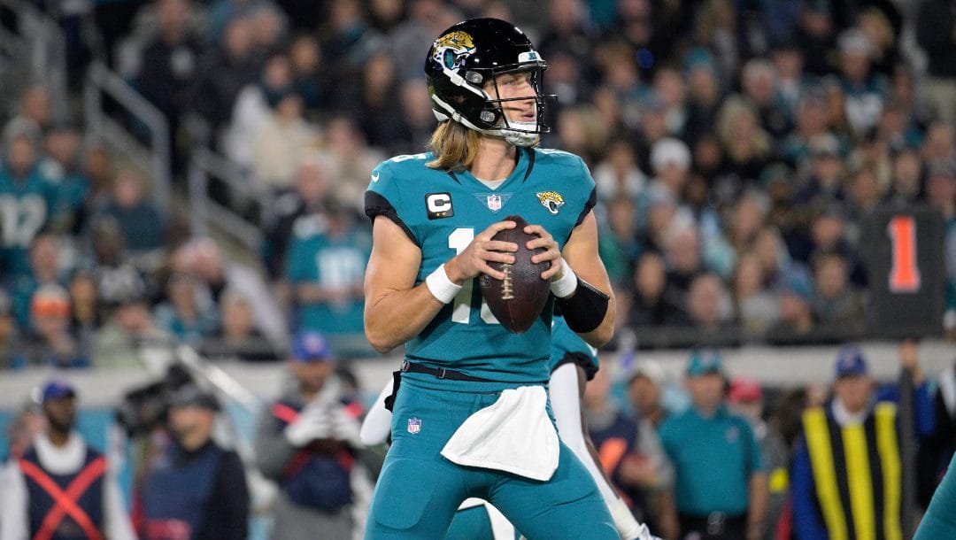 Jacksonville Jaguars quarterback Trevor Lawrence (16) looks for a receiver during the first half of an NFL football game against the Tennessee Titans, Saturday, Jan. 7, 2023, in Jacksonville, Fla.
