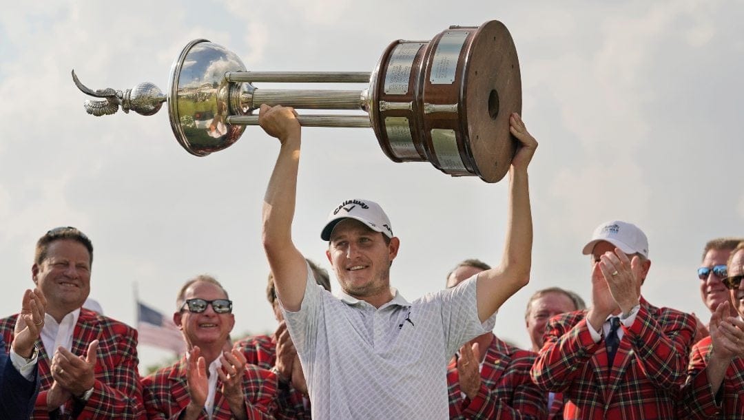 Emiliano Grillo, of Argentina, lifts the trophy after winning the Charles Schwab Challenge golf tournament at Colonial Country Club in Fort Worth, Texas, Sunday, May 28, 2023.