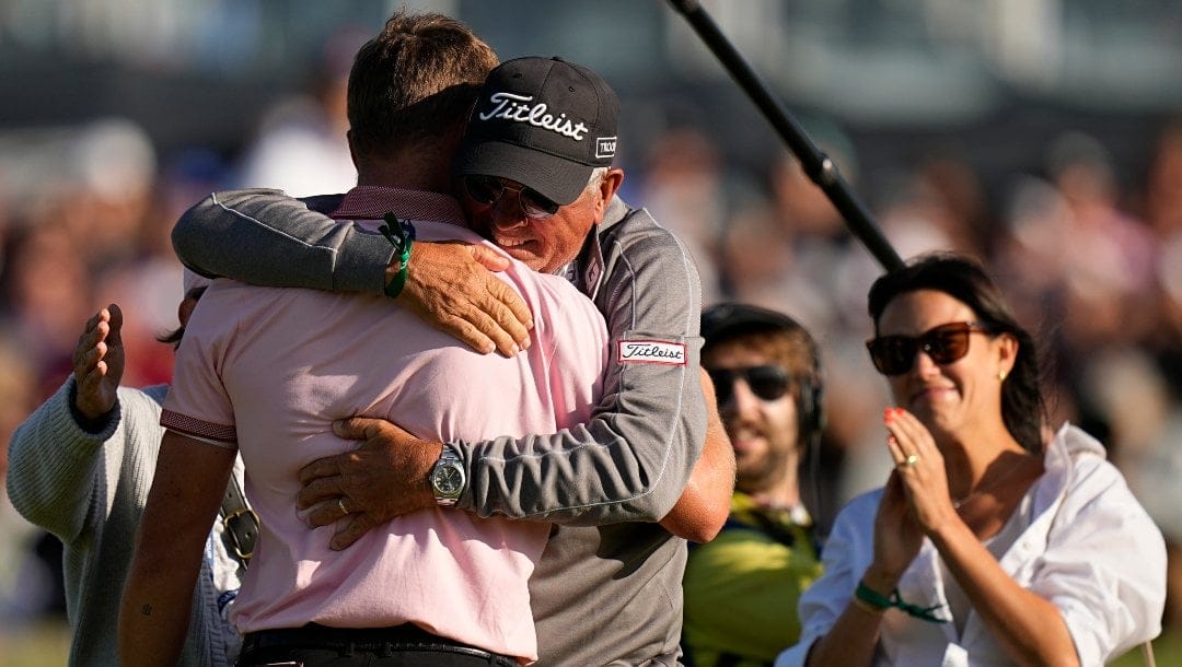Justin Thomas is greeted by is dad Mike after winning the PGA Championship golf tournament in a playoff against Will Zalatoris at Southern Hills Country Club, Sunday, May 22, 2022, in Tulsa, Okla.