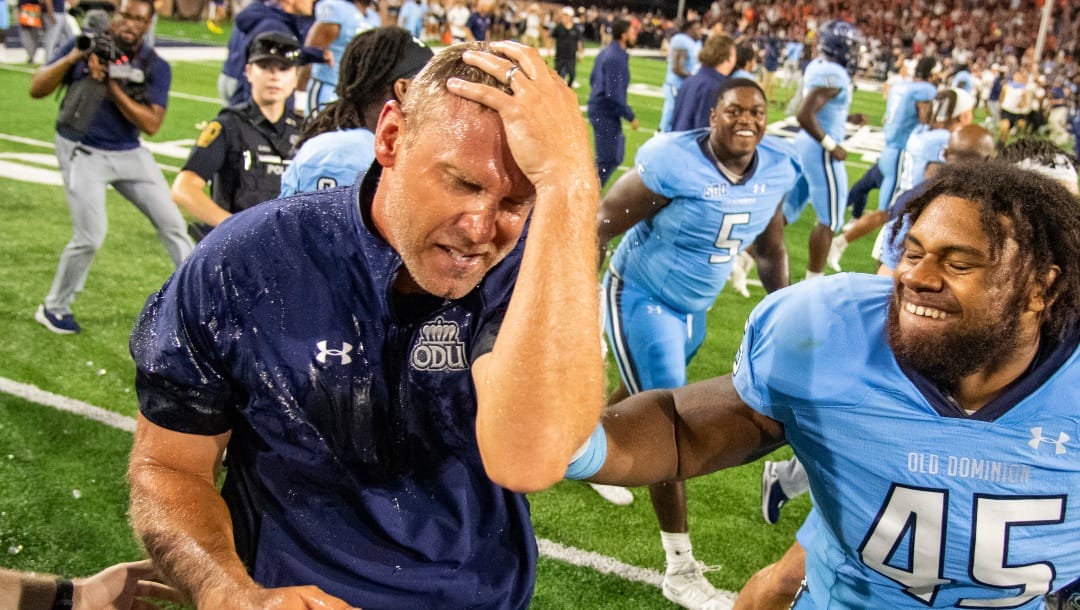 Old Dominion coach Ricky Rahne reacts after being doused, next to defensive tackle Denzel Lowry (45) after the team's win over Virginia Tech in an NCAA college football game Friday, Sept. 2, 2022, in Norfolk, Va. (AP Photo/Mike Caudill)