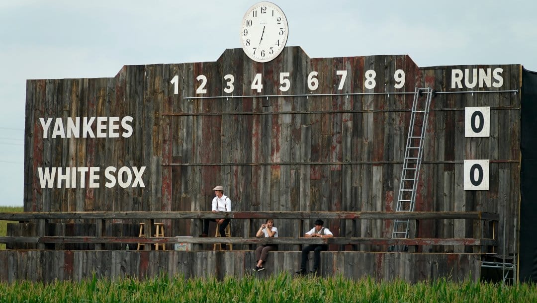 The scoreboard is shown in the outfield during a baseball game between the New York Yankees and Chicago White Sox, Thursday, Aug. 12, 2021 in Dyersville, Iowa. The Yankees and White Sox are playing at a temporary stadium in the middle of a cornfield at the Field of Dreams movie site, the first Major League Baseball game held in Iowa.