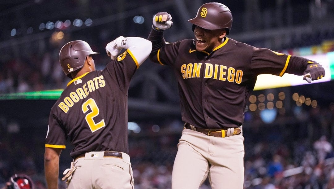 San Diego Padres' Juan Soto celebrates with teammate Xander Bogaerts (2) after scoring a home run during the seventh inning of a baseball game against the Washington Nationals in Washington, Tuesday, May 23, 2023.