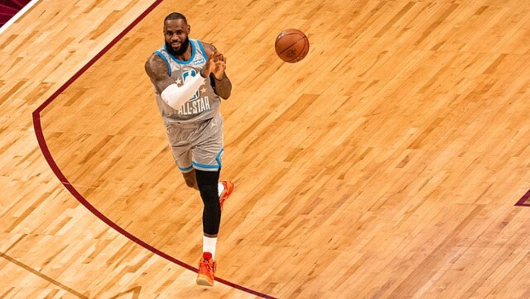 LeBron James passes the ball to his teammate during the 2022 NBA All-Star Game in his hometown in Cleveland.