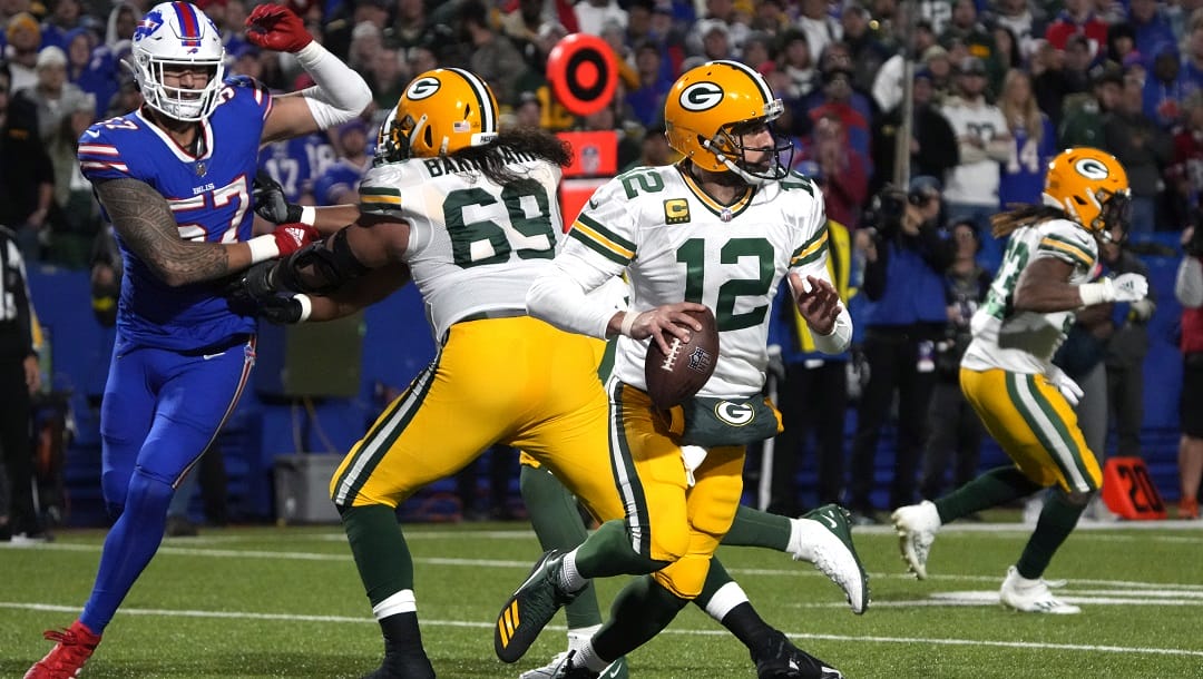 Green Bay Packers quarterback Aaron Rodgers (12) runs the ball against the Buffalo Bills during the first half of an NFL football game, Sunday, Oct. 30, 2022, in Buffalo, N.Y.