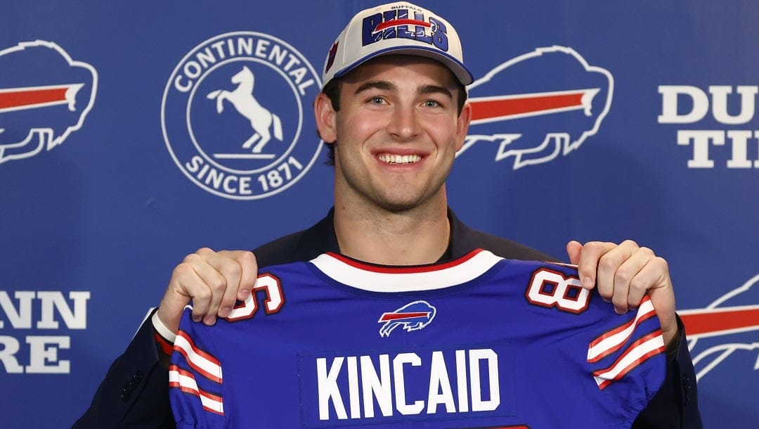 Buffalo Bills first-round draft pick Dalton Kincaid holds up a jersey during the NFL football team's news conference in Orchard Park, N.Y., Friday April 28, 2023.