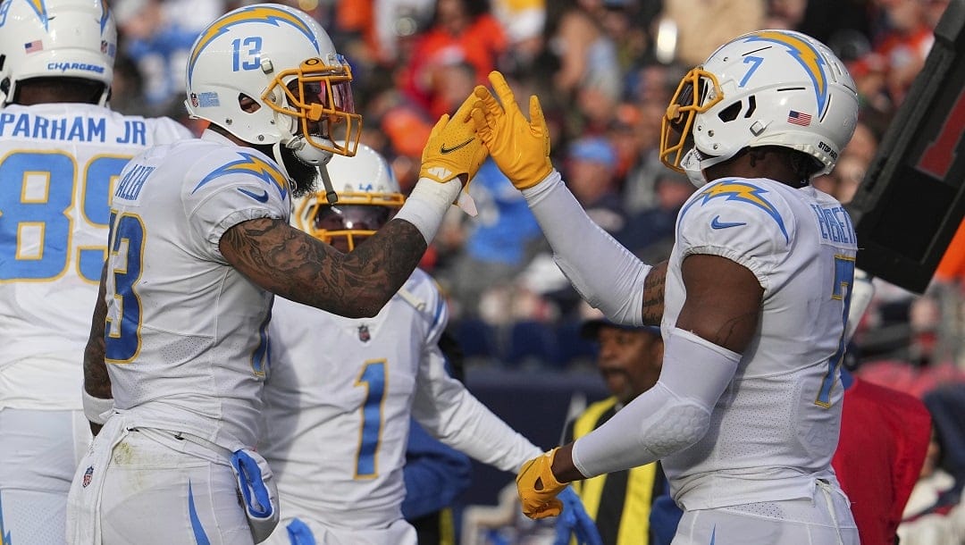 Los Angeles Chargers wide receiver Keenan Allen (13) and Los Angeles Chargers tight end Gerald Everett (7) celebrate against the Denver Broncos of an NFL football game Sunday, January 8, 2023, in Denver.