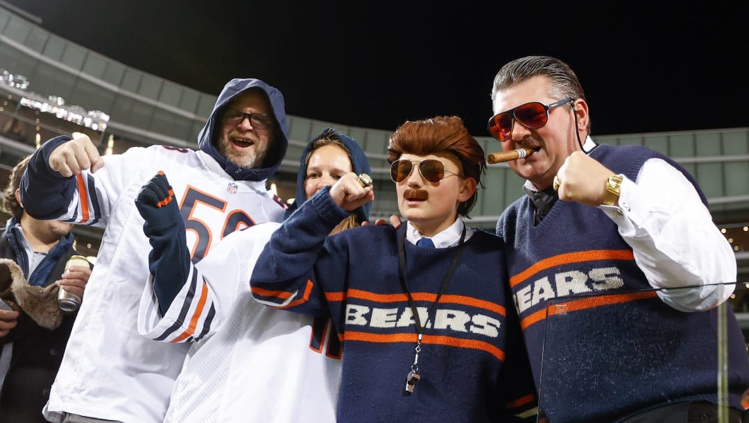 Chicago Bears fans cheer for their team before an NFL football game against the Washington Commanders, Thursday, Oct. 13, 2022, in Chicago. (AP Photo/Kamil Krzaczynski)