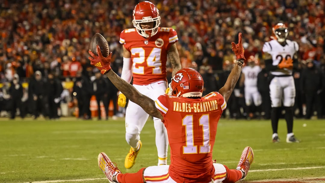 Kansas City Chiefs wide receiver Marquez Valdes-Scantling (11) celebrates his touchdown with Chiefs wide receiver Skyy Moore (24) as Cincinnati Bengals cornerback Cam Taylor-Britt (29) looks on during the second half of the NFL AFC Championship playoff football game, Sunday, Jan. 29, 2023 in Kansas City, Mo.
