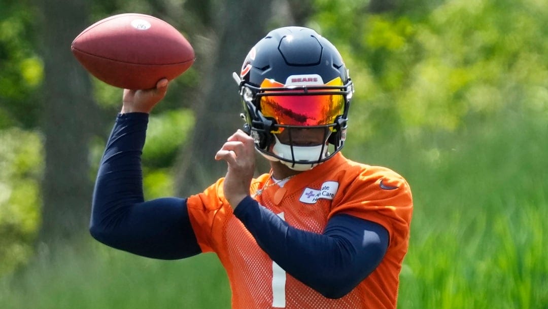 Chicago Bears quarterback Justin Fields works on the field during NFL football OTA practice in Lake Forest, Ill., Tuesday, May 23, 2023. (AP Photo/Nam Y. Huh)