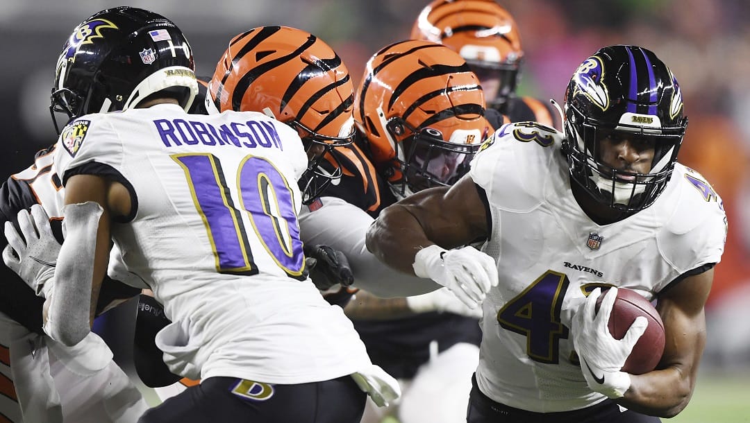 Baltimore Ravens running back Justice Hill (43) carries the ball during the first half of an NFL wild-card football game against the Cincinnati Bengals on Sunday, Jan. 15, 2023, in Cincinnati.