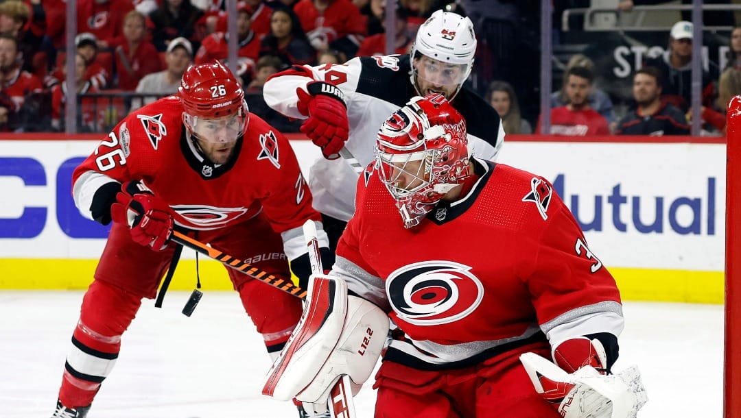 Carolina Hurricanes goaltender Frederik Andersen (31) blocks a shot as New Jersey Devils' Miles Wood (44) battles with Hurricanes' Paul Stastny (26) nearby during the third period of Game 5 of an NHL hockey Stanley Cup second-round playoff series in Raleigh, N.C., Thursday, May 11, 2023. (AP Photo/Karl B DeBlaker)