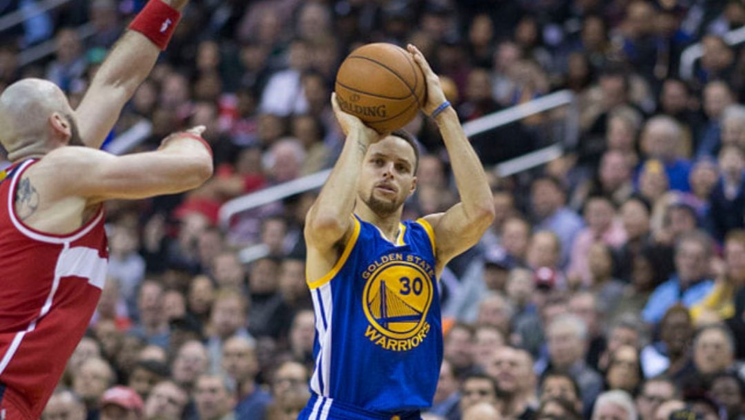 Stephen Curry of the Golden State Warriors shoots against Washington Wizards’ Marcin Gortat in an NBA game in 2016.