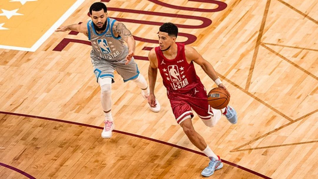 Devin Booker of the Phoenix Suns drives past Fred VanVleet of the Toronto Raptors during the 2022 NBA All-Star Game.