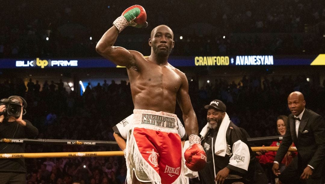 Terence Crawford raises his fist after knocking out David Avanesyan in the sixth round.