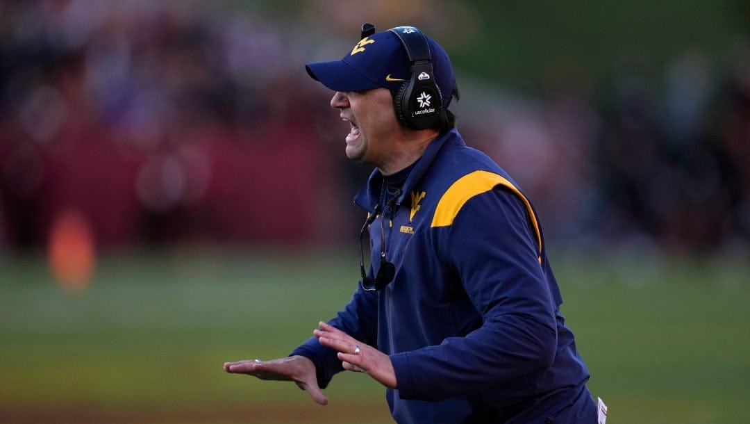West Virginia head coach Neal Brown questions a call against his team during the second half of an NCAA college football game against Iowa State, Saturday, Nov. 5, 2022, in Ames, Iowa. Iowa State 31-14.