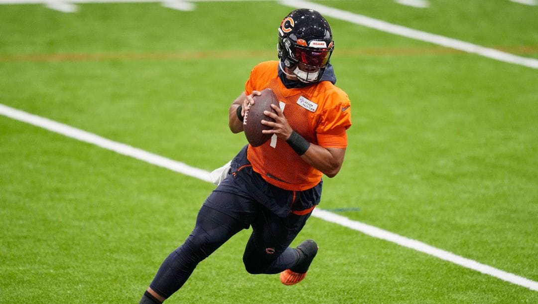 Chicago Bears quarterback Justin Fields works on the field during NFL football practice in Lake Forest, Ill., Tuesday, June 13, 2023.