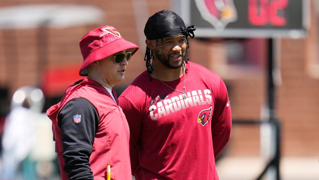 Arizona Cardinals quarterback Kyler Murray, right, talks with Cardinals offensive coordinator Drew Petzing, left, during during OTA workouts at the NFL football team's training facility Monday, May 22, 2023, in Tempe, Ariz.