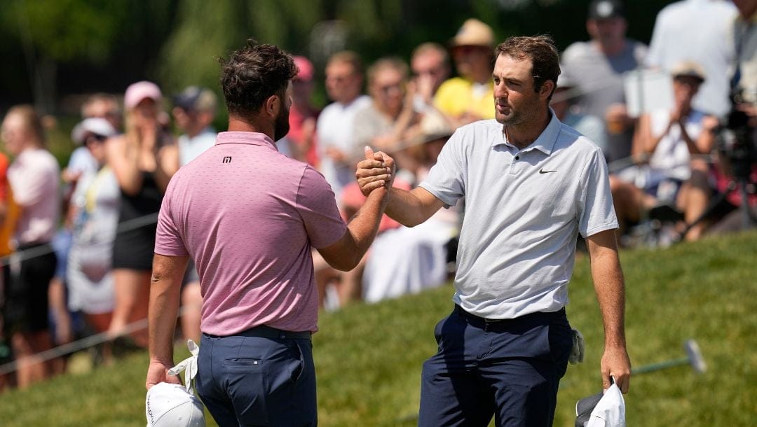 Jon Rahm, left, of Spain, and Scottie Scheffler, right, shake hands after the final round of the Memorial golf tournament, Sunday, June 4, 2023, in Dublin, Ohio.