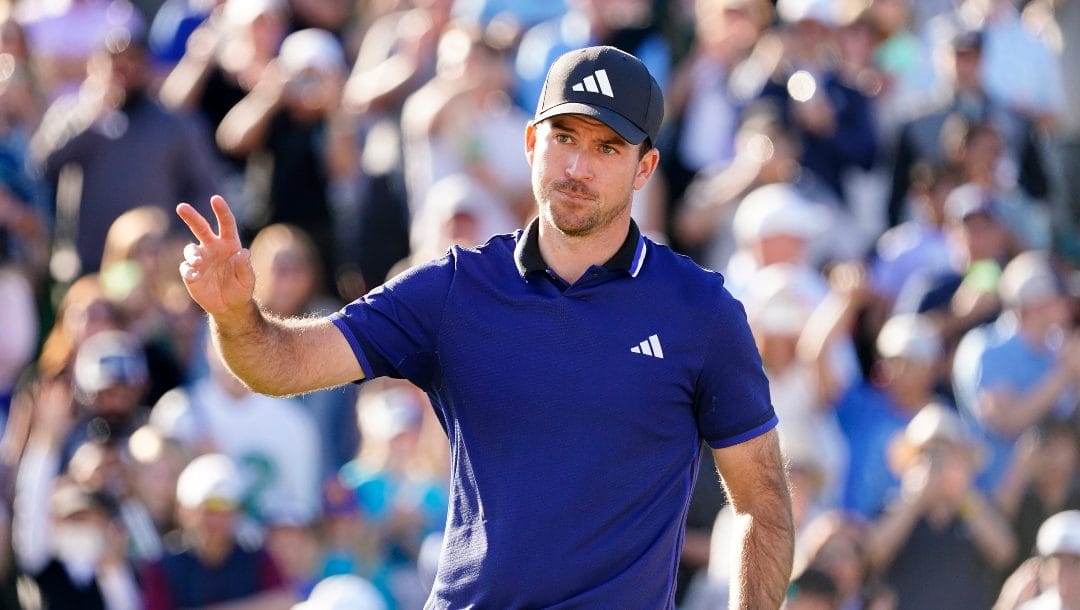 Nick Taylor acknowledges the crowd on the 18th hole during the final round of the Phoenix Open golf tournament, Sunday, Feb. 12, 2023, in Scottsdale, Ariz.