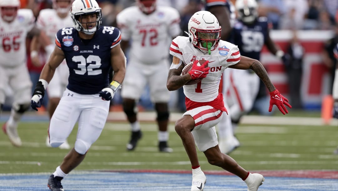 Houston wide receiver Nathaniel Dell (1) carries the ball after a reception against Auburn during the second of the Birmingham Bowl NCAA college football game Tuesday, Dec. 28, 2021, in Birmingham, Ala.
