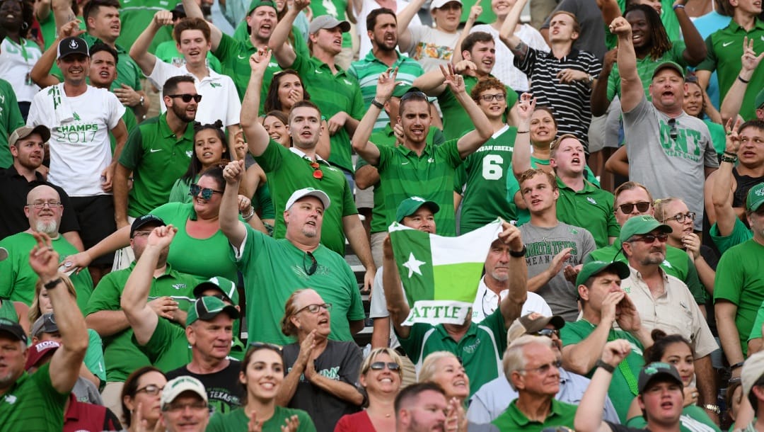 North Texas cheer as the Mean Green beat Arkansas 44-17 in the second half of an NCAA college football game Saturday, Sept. 15, 2018, in Fayetteville, Ark. (AP Photo/Michael Woods)