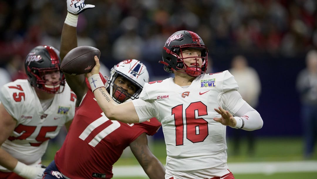 Western Kentucky quarterback Austin Reed (16) throws against South Alabama defensive lineman Jamie Sheriff (11) during the first half of the New Orleans Bowl NCAA college football game in New Orleans, Wednesday, Dec. 21, 2022.