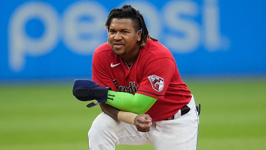 Cleveland Guardians' Jose Ramirez kneels at second base during a visit to the mound in the seventh inning of a baseball game against the Houston Astros, Saturday, June 10, 2023, in Cleveland. (AP Photo/Sue Ogrocki)