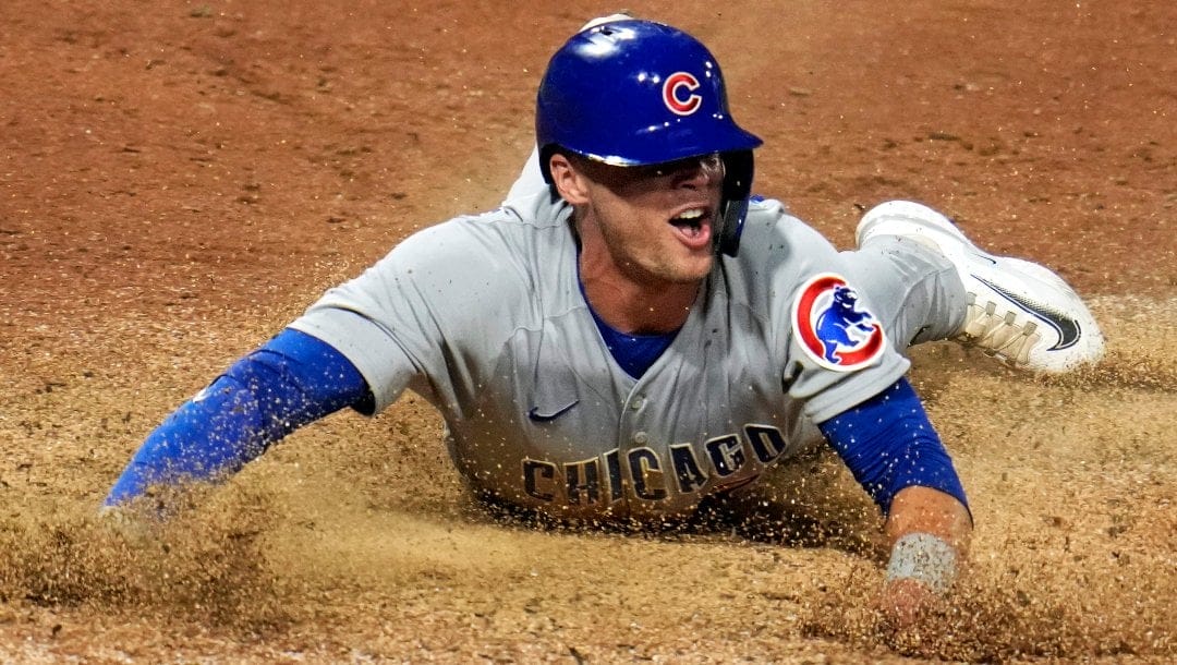 Chicago Cubs' Nico Hoerner scores on a sacrifice by by Seiya Suzuki off Pittsburgh Pirates relief pitcher Dauri Moreta during the eighth inning of a baseball game in Pittsburgh, Tuesday, June 20, 2023. The Cubs won 4-0.