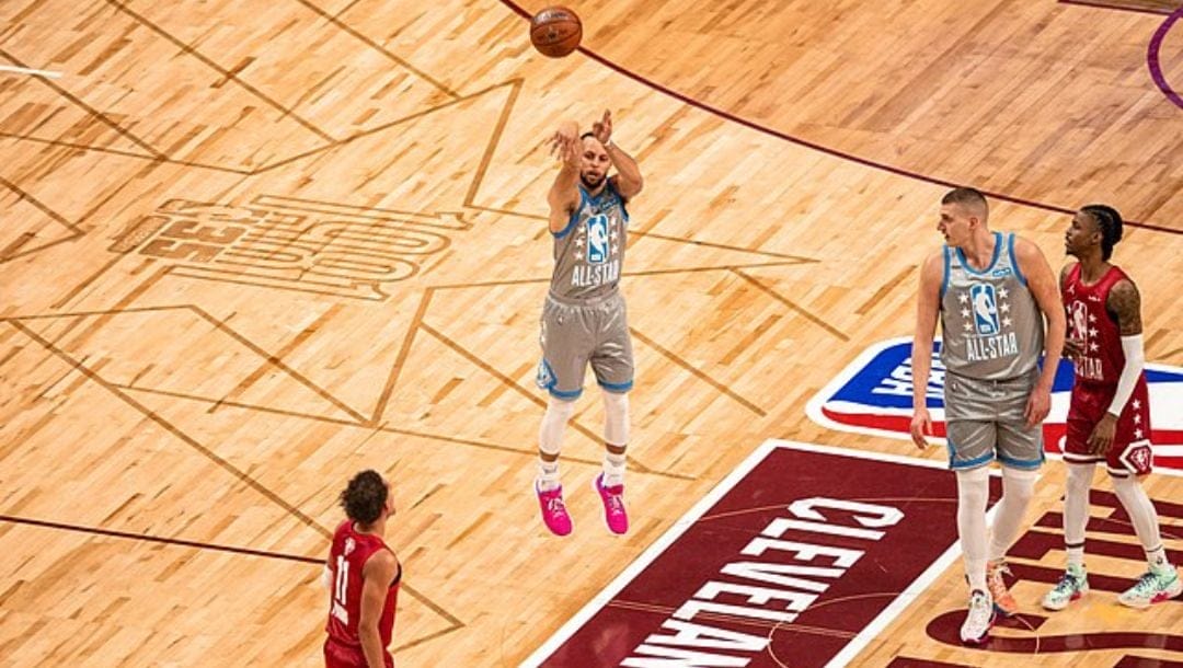 Golden State Warriors superstar Stephen Curry shoots a long-range three-point shot during the 2022 NBA All-Star game.