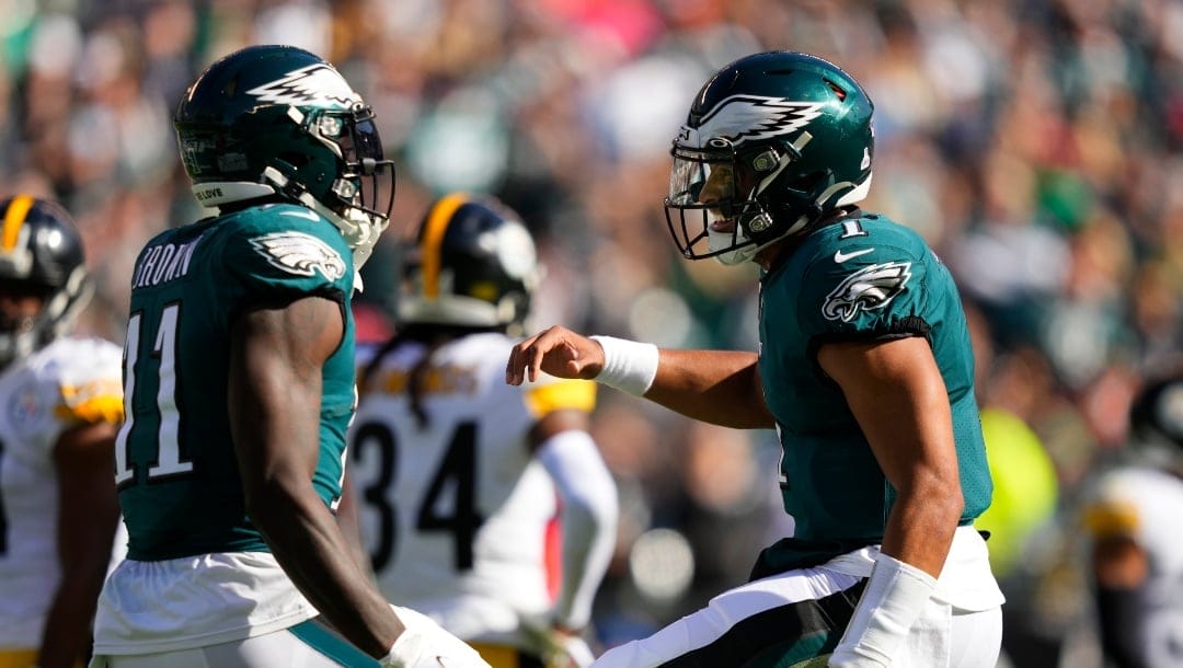 Philadelphia Eagles wide receiver A.J. Brown (11) celebrates his third touchdown reception with quarterback Jalen Hurts during the first half of an NFL football game between the Pittsburgh Steelers and Philadelphia Eagles, Sunday, Oct. 30, 2022, in Philadelphia. (AP Photo/Matt Slocum)