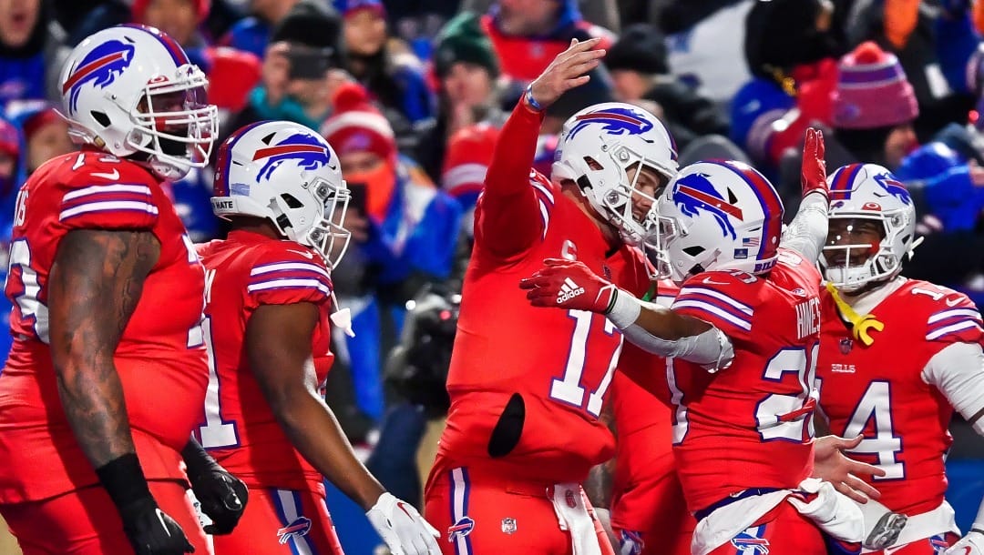 Buffalo Bills running back Nyheim Hines (20) celebrates with quarterback Josh Allen (17) after scoring a touchdown against the Miami Dolphins during the first half of an NFL football game in Orchard Park, N.Y., Saturday, Dec. 17, 2022. (AP Photo/Adrian Kraus)
