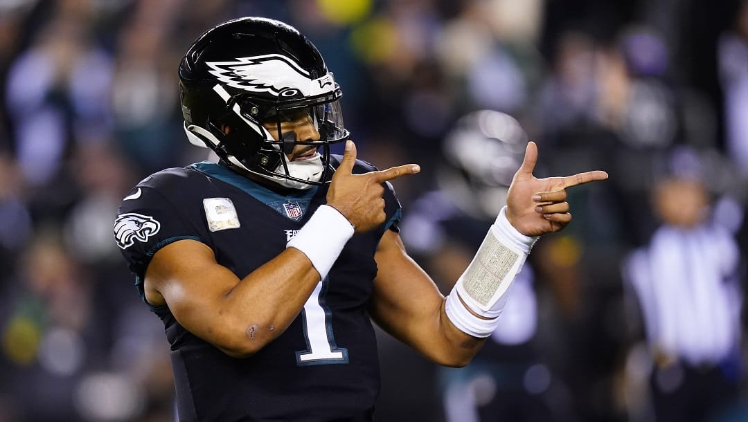 Philadelphia Eagles quarterback Jalen Hurts celebrates a touchdown run by Kenneth Gainwell during the first half of the team's NFL football game against the Green Bay Packers on Nov. 27, 2022, in Philadelphia. Jalen Hurts is set to sign one of the richest deals in NFL history, agreeing to a five-year, $255 million extension with the Philadelphia Eagles, including $179.3 million guaranteed, a person with knowledge of the situation told The Associated Press. The Eagles announced on Monday, April 17, “QB1 is here to stay,” but terms were not yet announced, according to the person who spoke to the AP on condition of anonymity because the deal was not yet final.