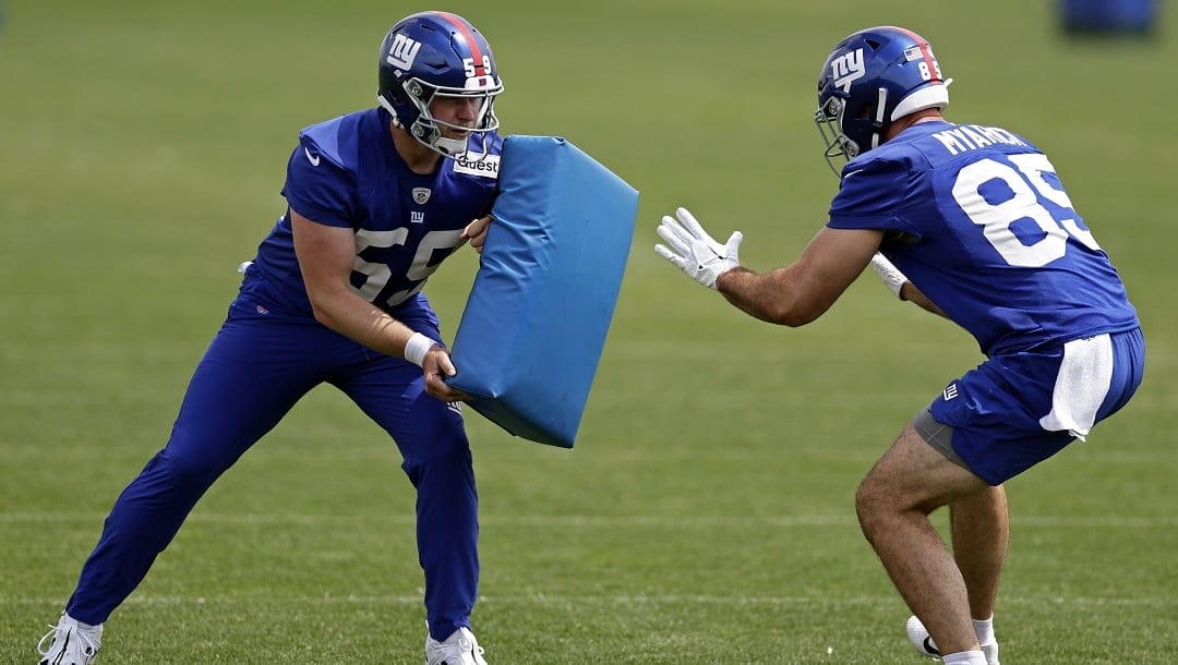 New York Giants long snapper Casey Kreiter and Chris Myarick (85) run a drill during the NFL football team's practice on Wednesday, June 14, 2023, in East Rutherford, N.J.