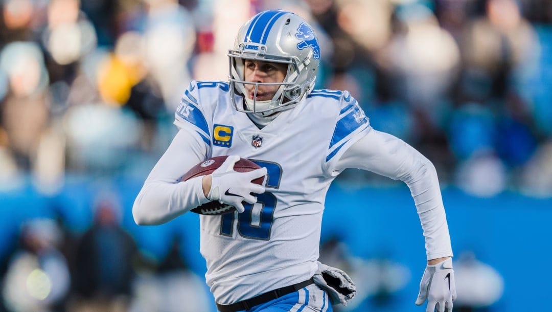 Detroit Lions quarterback Jared Goff (16) runs with the ball during an NFL football game between the Carolina Panthers and the Detroit Lions on Saturday, Dec. 24, 2022, in Charlotte, N.C. (AP Photo/Jacob Kupferman)