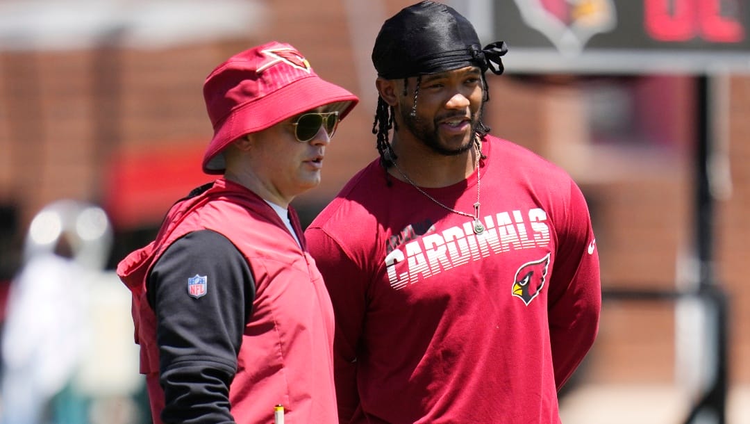 Arizona Cardinals quarterback Kyler Murray, right, talks with Cardinals offensive coordinator Drew Petzing, left, during during OTA workouts at the NFL football team's training facility Monday, May 22, 2023, in Tempe, Ariz. (AP Photo/Ross D. Franklin)