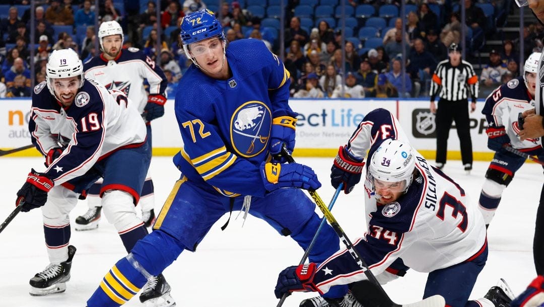 Buffalo Sabres center Tage Thompson (72) and Columbus Blue Jackets center Cole Sillinger (34) compete during a faceoff during the first period of an NHL hockey game Feb. 28, 2023, in Buffalo, N.Y.