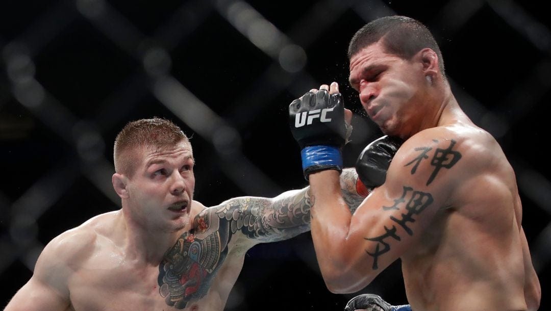 Marvin Vettori, left, punches Cezar Ferreira during a middleweight mixed martial arts fight at UFC Fight Night in Sacramento.