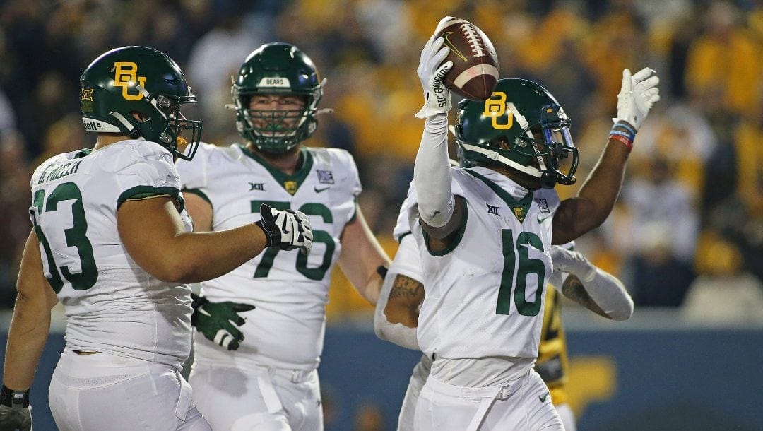 Baylor players celebrate after a touchdown during the second half of an NCAA college football game against West Virginia in Morgantown, W.Va., Thursday, Oct. 13, 2022.