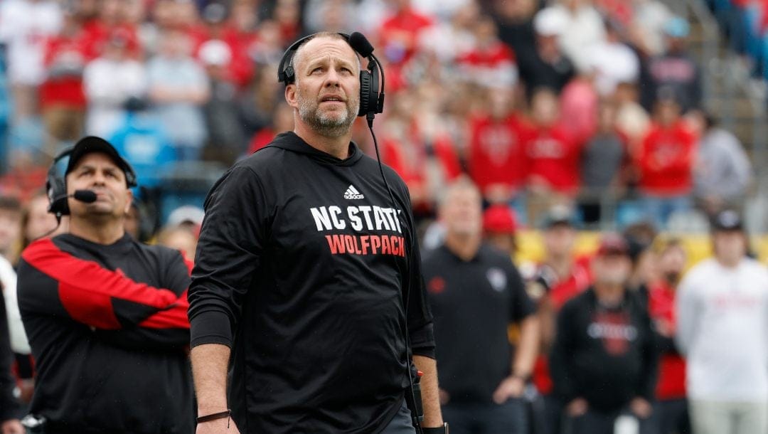 North Carolina State head coach Dave Doeren watches a replay as his team plays against Maryland in the Duke's Mayo Bowl NCAA college football game in Charlotte, N.C., Friday, Dec. 30, 2022. Maryland defeated North Carolina State 16-12.