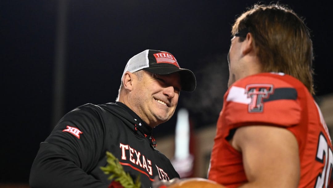 Texas Tech head coach Joey McGuire shakes hands with defensive back Jett Whitfield (38) on senior night before an NCAA college football game against Oklahoma Saturday, Nov. 26, 2022, in Lubbock, Texas.