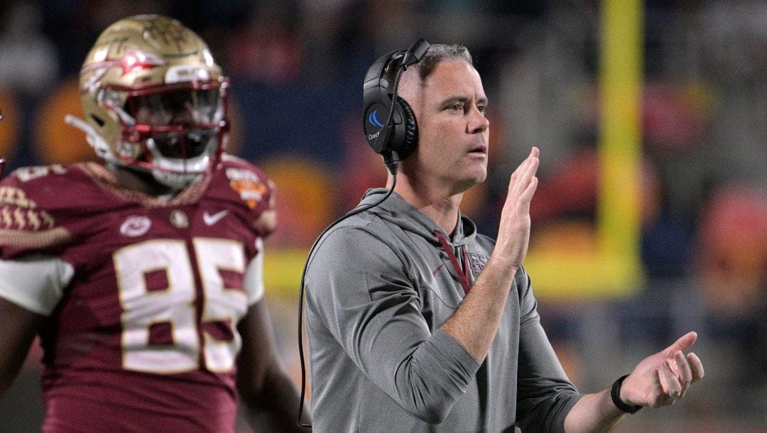 Florida State coach Mike Norvell, right, applauds after a successful 2-point conversion during the first half of the team's Cheez-It Bowl NCAA college football game against Oklahoma, Thursday, Dec. 29, 2022, in Orlando, Fla.