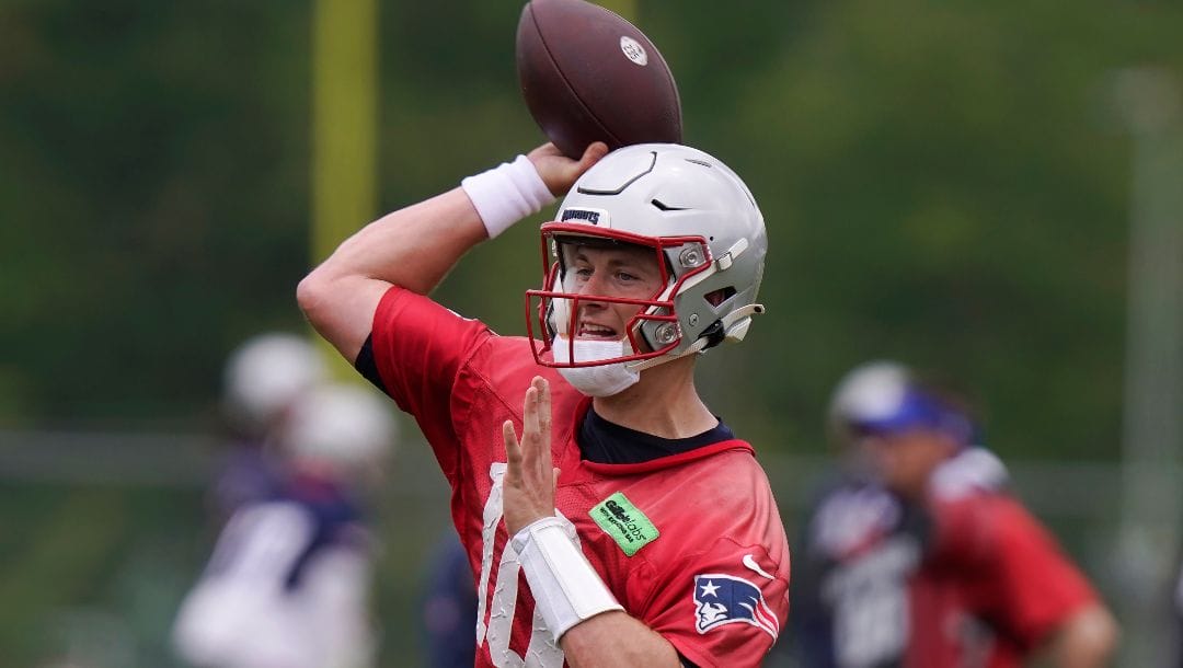 New England Patriots quarterback Mac Jones winds up to pass at the NFL football team's practice facility June 13, 2023, in Foxborough, Mass. Patriots coach Bill Belichick's decision to entrust his offense and the development of Jones to two unproven offensive coaches was a disaster.