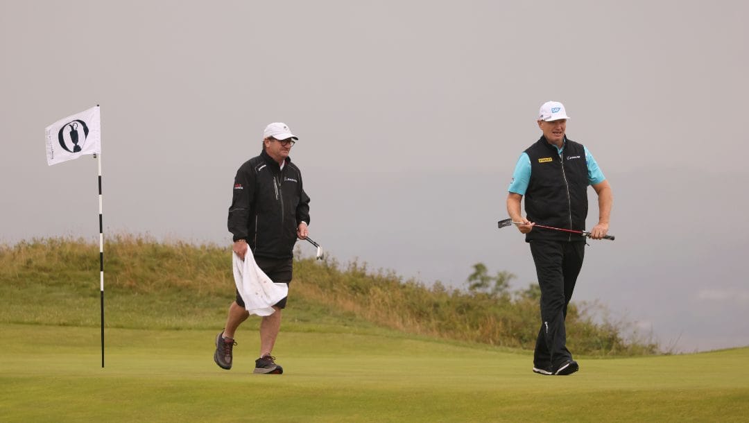 South Africa's Ernie Els, right, walks on the 14th green during a practice round for the British Open Golf Championships at the Royal Liverpool Golf Club in Hoylake, England, Monday, July 17, 2023. The Open starts Thursday, July 20.